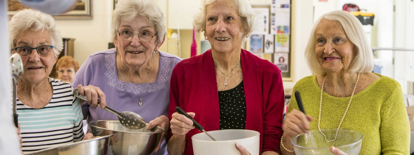 A group of residents enjoying cooking together at The Cooking Club, a creative cooking program developed by Whiddon.