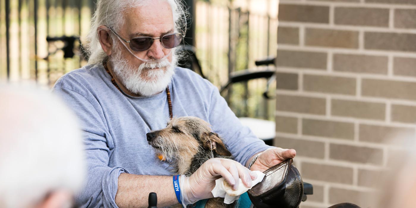 A resident with a dog as part of pet therapy at Whiddon Kelso.