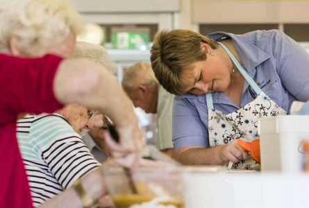 A Whiddon carer with residents baking at an aged care home in Tamworth.