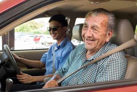 A carer with a resident enjoying a car ride as part of assisted transport services at Whiddon Narrabri.