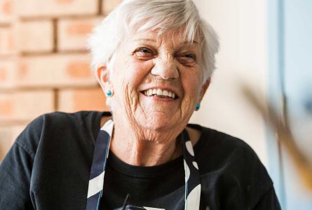 A close up shot of a resident laughing at Whiddon’s Far North Coast community care home.