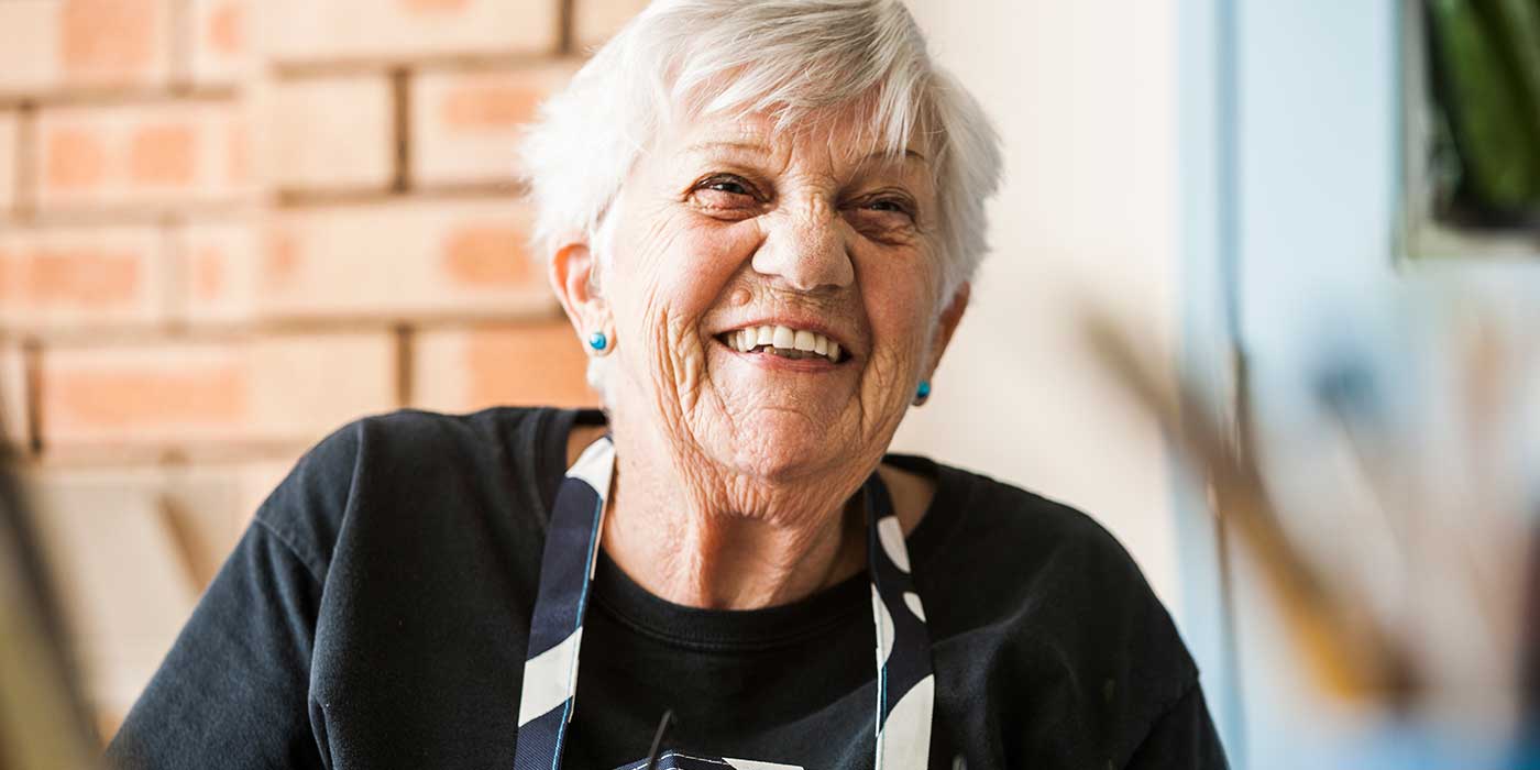 A close up shot of a resident laughing at Whiddon’s Far North Coast community care home.