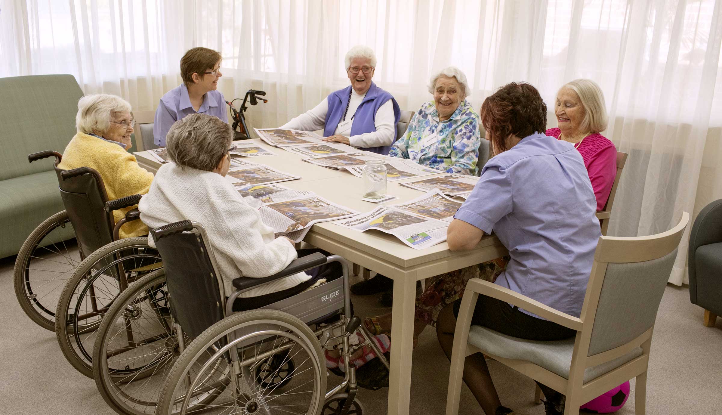 Residents enjoying a cognitive stimulation therapy session with a carer at Whiddon Narrabri.