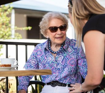 senior lady out at coffee shop with carer